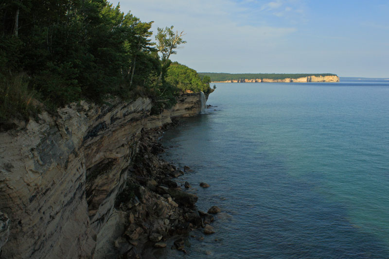 spray falls with grand portal point on the horizon in pictured rocks